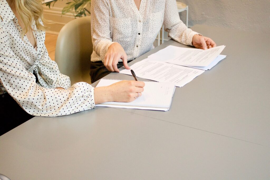two individuals signing a contract with employee arbitration clauses