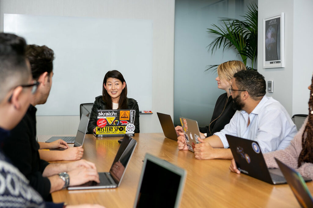 woman at the head of the table leading a meeting - active listening can help your career