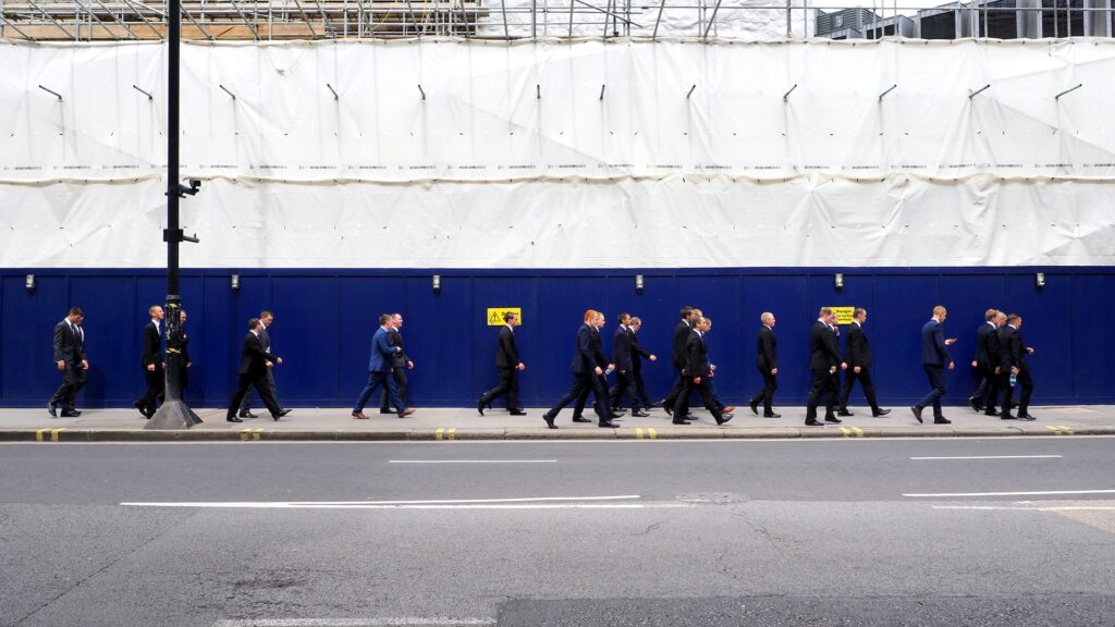 men in suits going to work - wage theft - hypertime